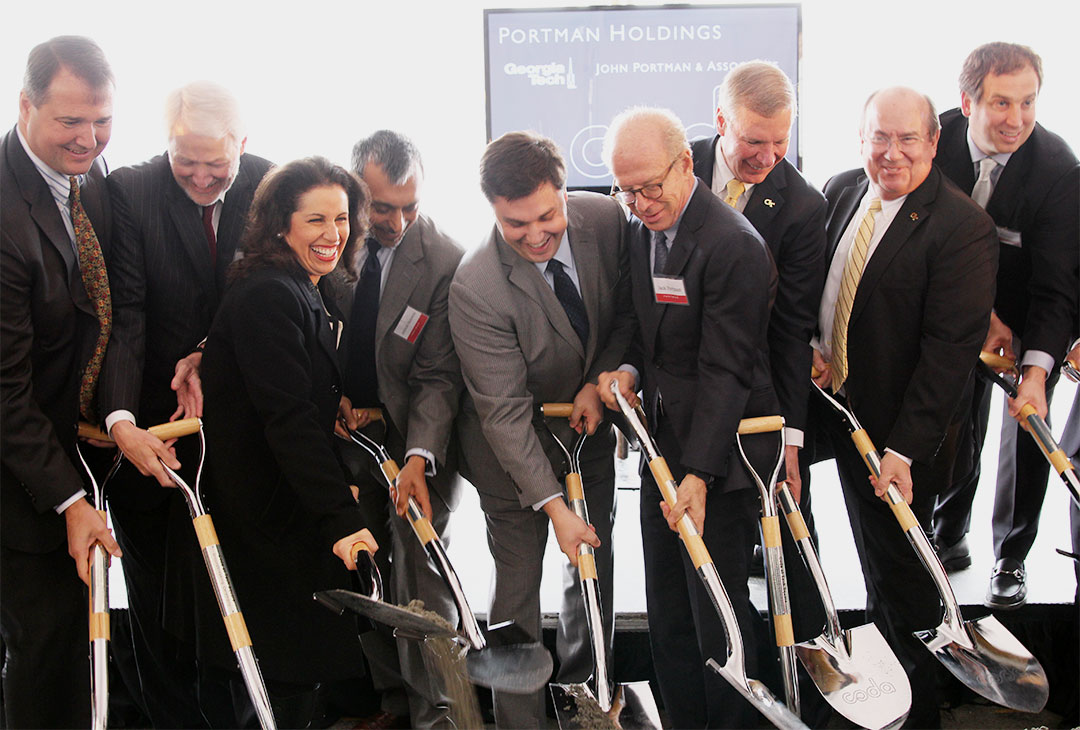 A line of several people holding shovels at the Coda groundbreaking