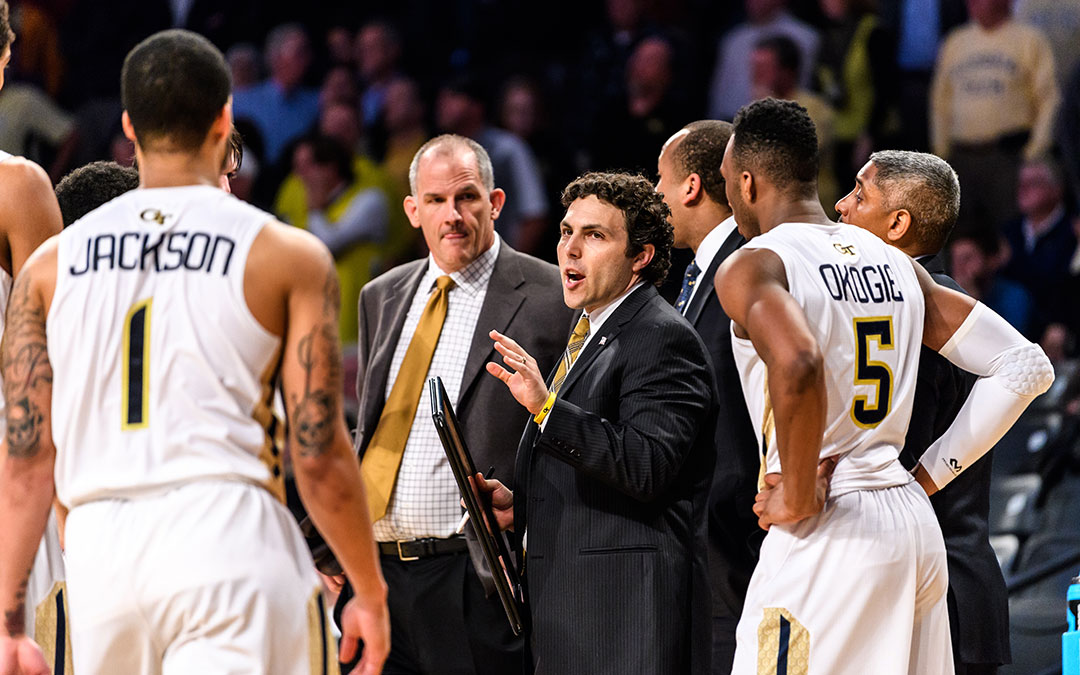 Josh Pastner during a game with assistant coaches and players around him