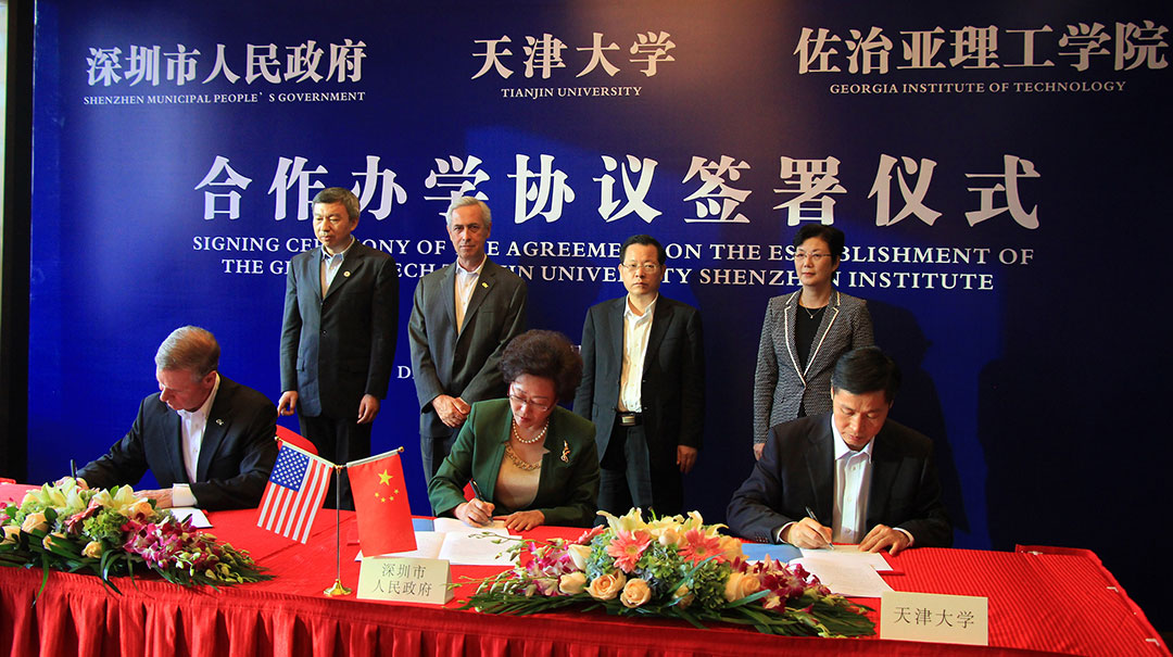 Several representatives from the U.S. and China signing documents pertaining to the Shenzhen partnership