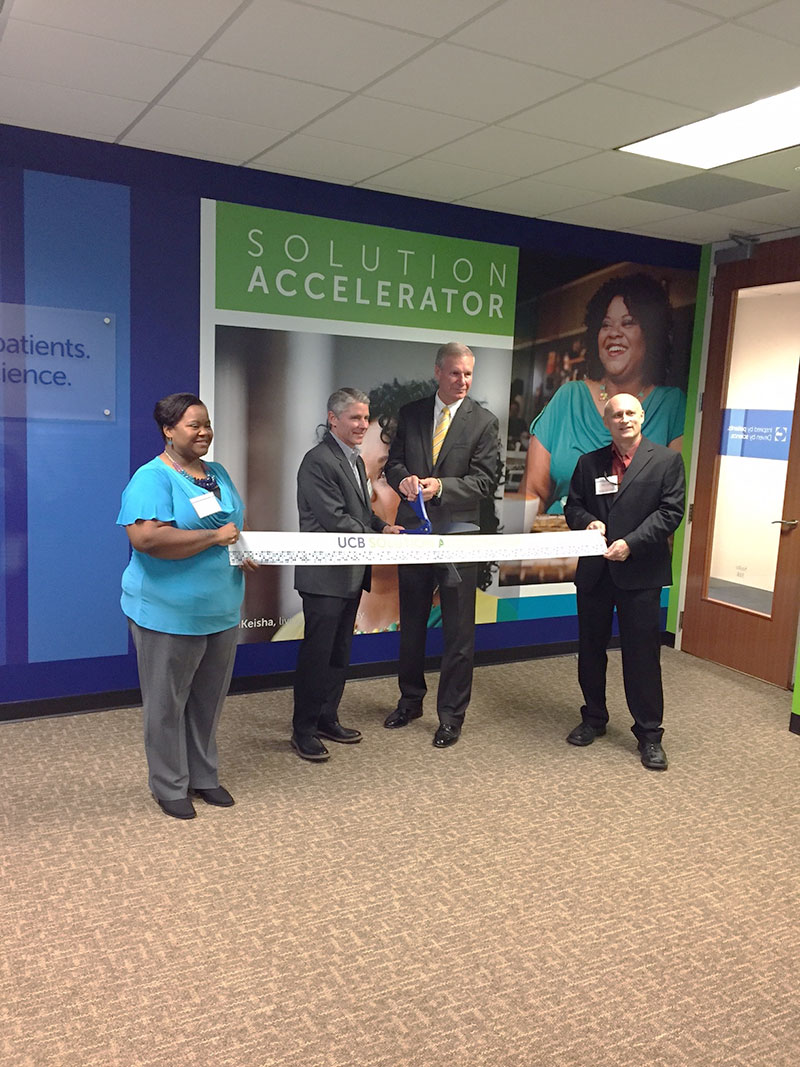 A group of people, including Georgia Tech president Peterson, prepare to cut a ribbon that says UCB Solution Accelerator