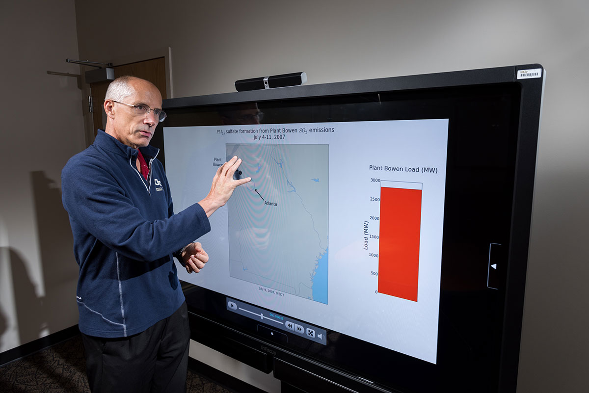 Ted Russell standing in front of a presentation screen